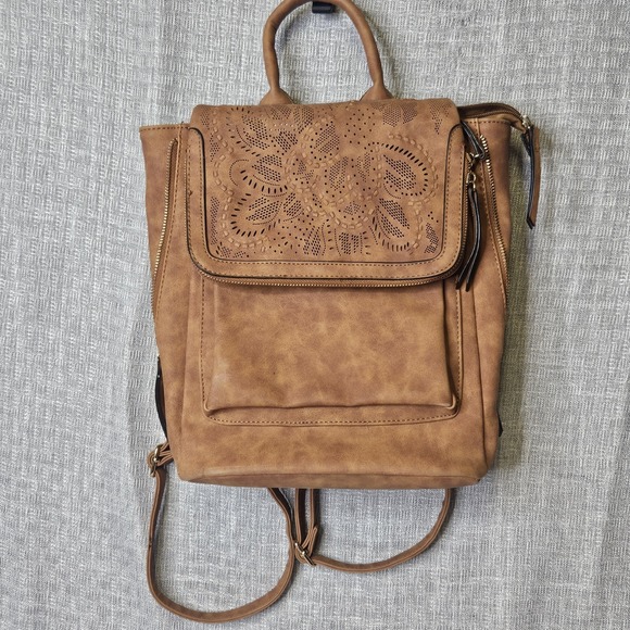 The Unbranded Brand Handbags - Backpack/ Carry All made from faux leather with a stamped/embossed‎ finish.